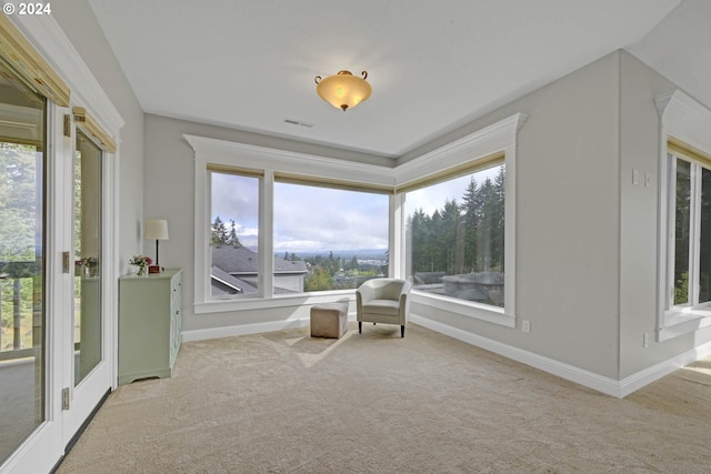 living area with light carpet and a wealth of natural light