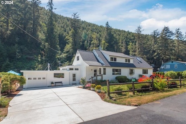 view of front of home featuring a mountain view and a garage