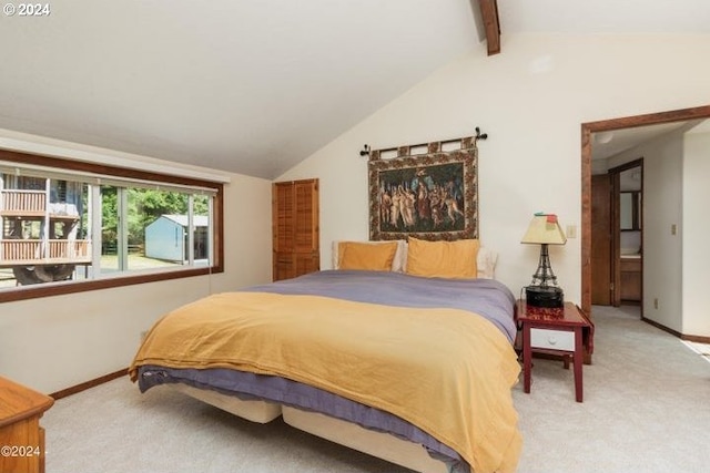 carpeted bedroom featuring lofted ceiling with beams