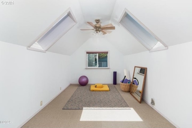 additional living space featuring a skylight, carpet, ceiling fan, and vaulted ceiling