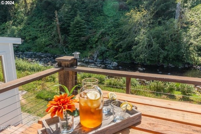 wooden deck with a wooded view