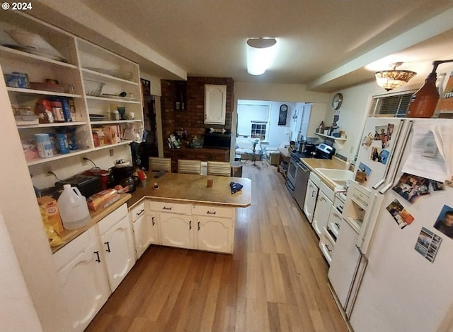 kitchen with sink, light hardwood / wood-style flooring, white refrigerator with ice dispenser, stainless steel electric range, and white cabinets