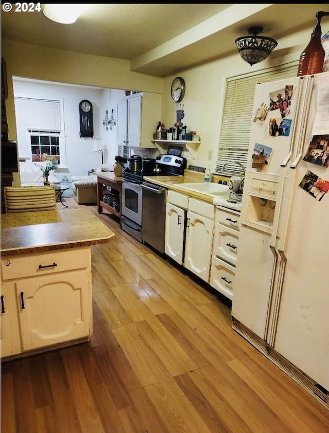 kitchen featuring dishwasher, white refrigerator with ice dispenser, and light wood-type flooring