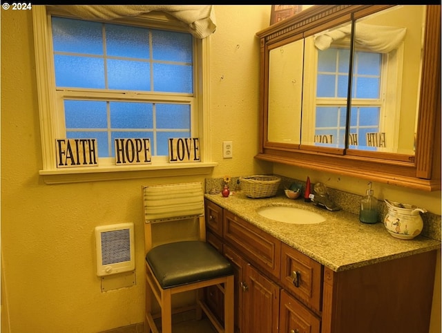 bathroom featuring vanity and heating unit