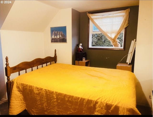 bedroom with lofted ceiling