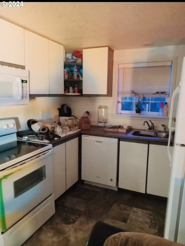 kitchen featuring white cabinets, white appliances, and sink