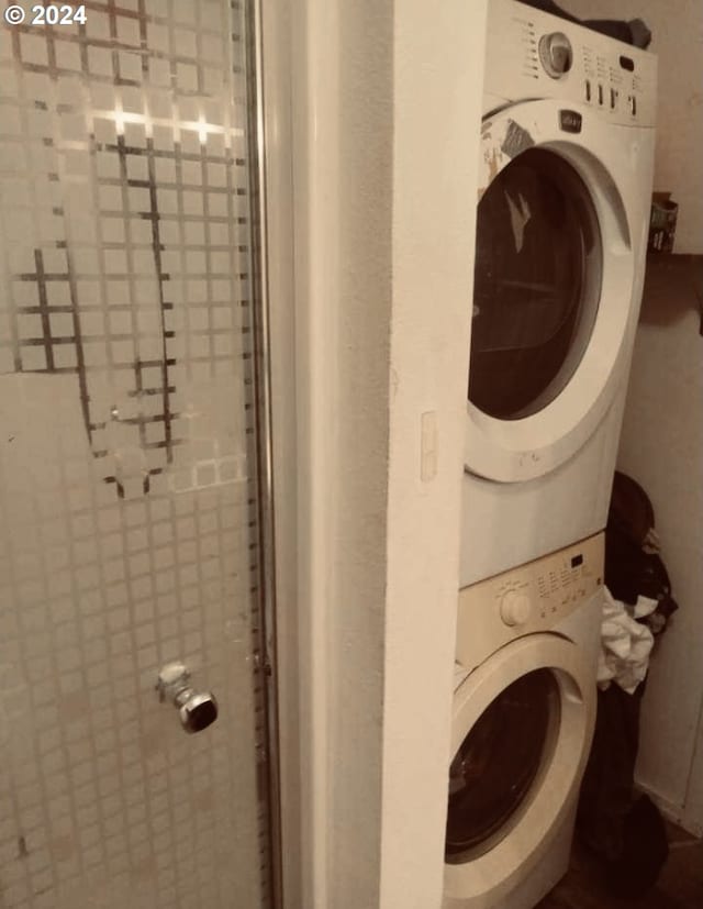 laundry area with stacked washer / dryer