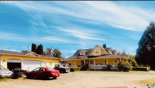 view of front of property with covered porch and a garage