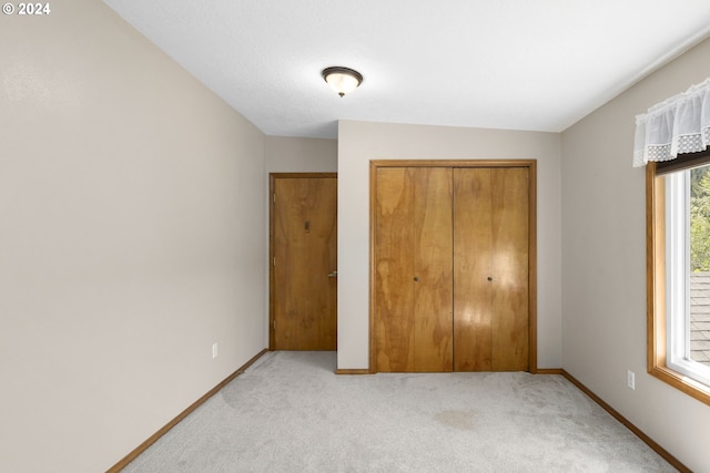 unfurnished bedroom featuring a closet and carpet