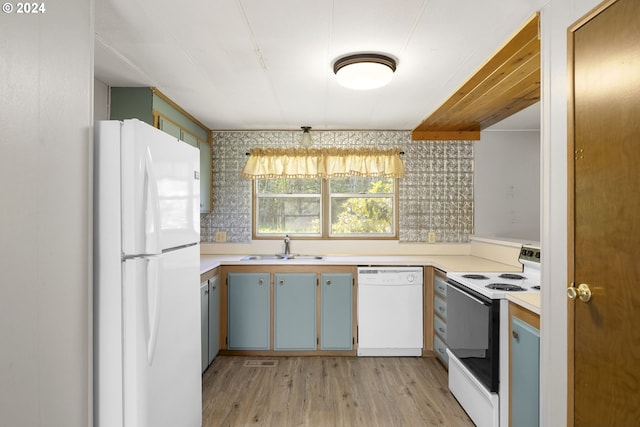 kitchen with light hardwood / wood-style floors, sink, and white appliances