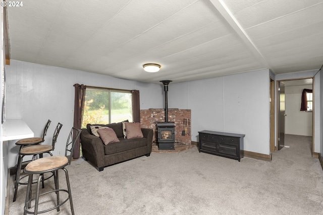 carpeted living room featuring a wood stove