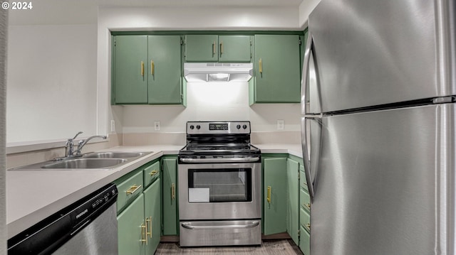 kitchen featuring green cabinets, stainless steel appliances, and sink