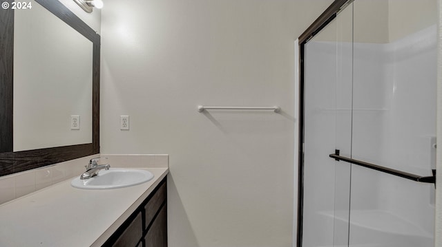 bathroom with vanity and an enclosed shower