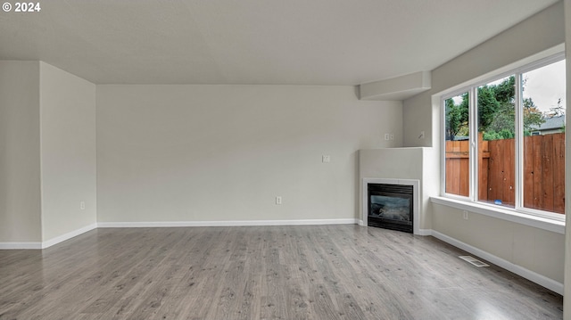 unfurnished living room featuring light hardwood / wood-style floors