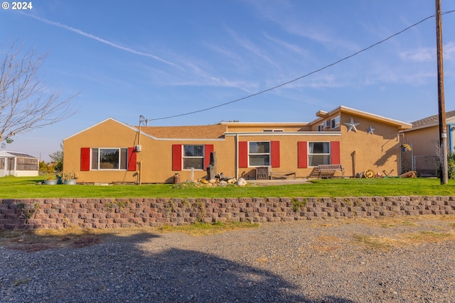 ranch-style home with a front lawn