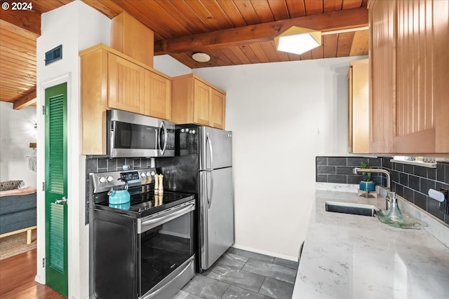 kitchen with appliances with stainless steel finishes, beamed ceiling, light brown cabinetry, sink, and backsplash