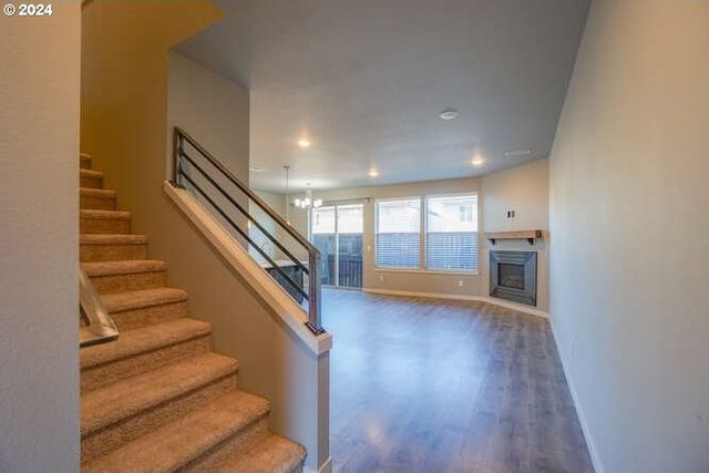 interior space with hardwood / wood-style floors and an inviting chandelier