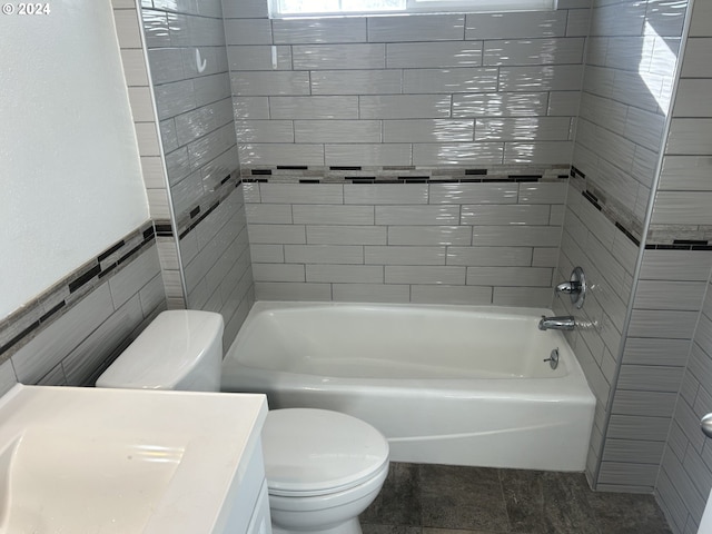 bathroom featuring  shower combination, toilet, and tile walls