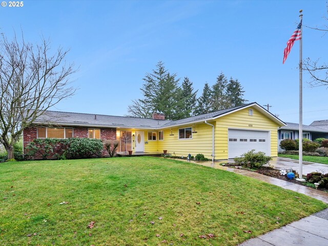 single story home with a front yard and a garage