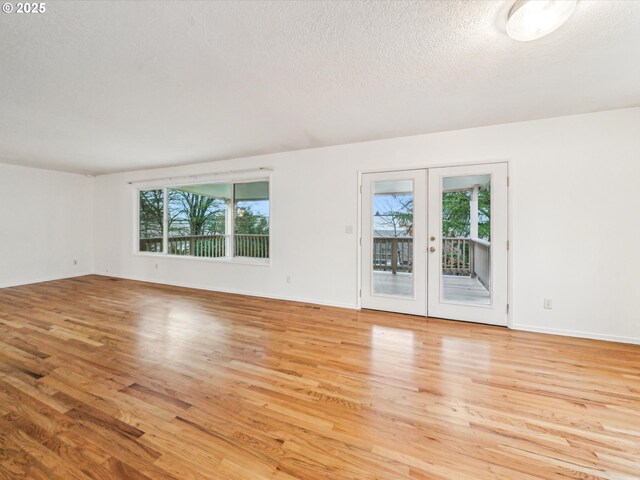 spare room featuring a textured ceiling and french doors