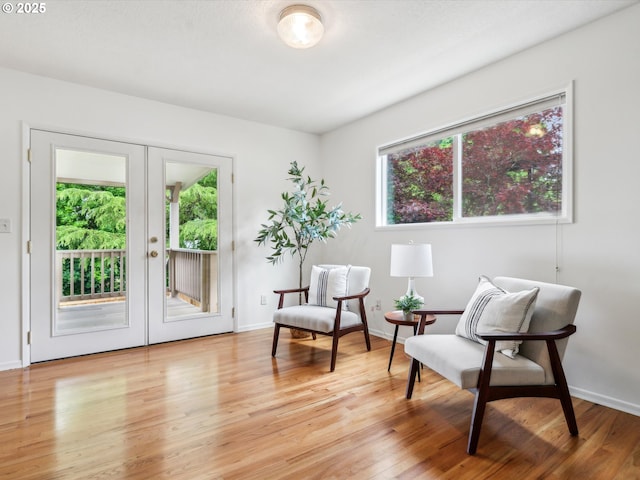 6325 SW Elm Ave, Beaverton, OR 97005 - living area with light wood finished floors, french doors, and baseboards