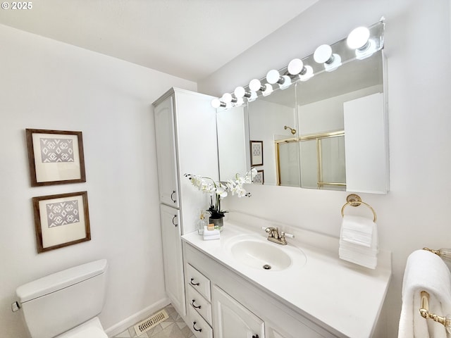 full bathroom featuring a stall shower, baseboards, toilet, tile patterned flooring, and vanity