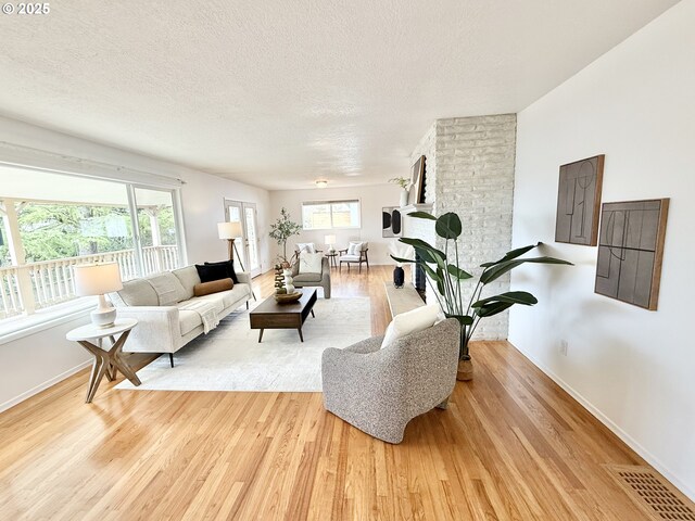 living room featuring a fireplace and light hardwood / wood-style flooring