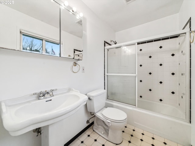 full bathroom featuring toilet, enclosed tub / shower combo, and sink