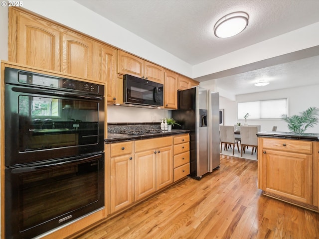 6325 SW Elm Ave, Beaverton, OR 97005 - kitchen with black appliances, dark countertops, light wood-style flooring, and a textured ceiling