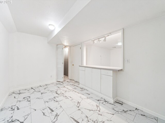 unfurnished bedroom with ceiling fan, a closet, light hardwood / wood-style floors, and a textured ceiling