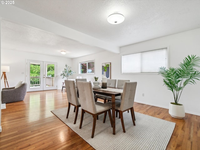 6325 SW Elm Ave, Beaverton, OR 97005 - dining area featuring beamed ceiling, wood finished floors, a textured ceiling, baseboards, and french doors