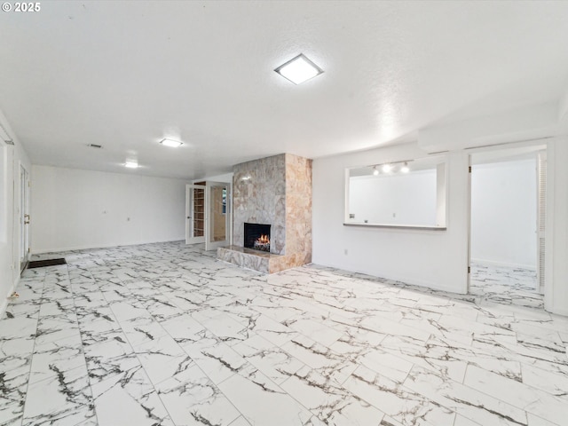 unfurnished living room featuring a fireplace and a textured ceiling