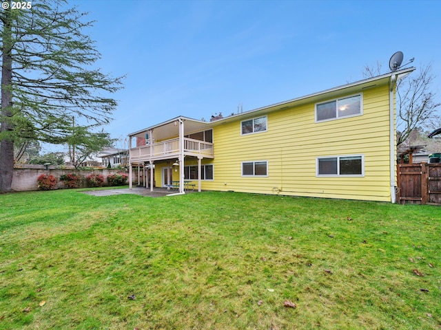 rear view of house featuring a yard, a patio area, and a fenced backyard