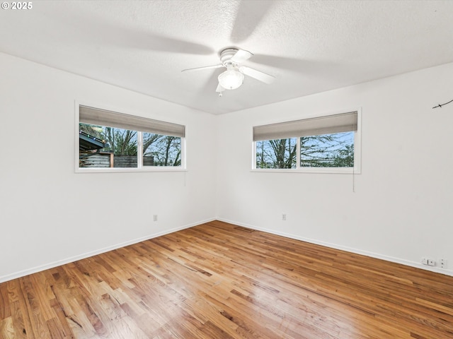 6325 SW Elm Ave, Beaverton, OR 97005 - spare room with light wood-type flooring, ceiling fan, baseboards, and a textured ceiling