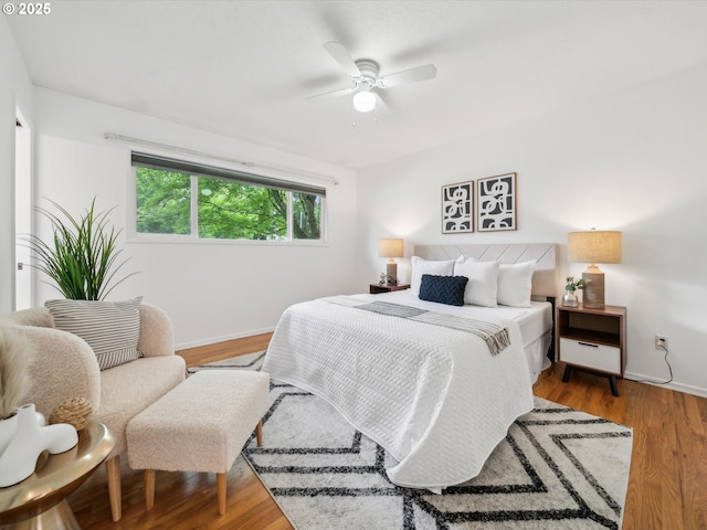 6325 SW Elm Ave, Beaverton, OR 97005 - bedroom with baseboards, wood finished floors, and a ceiling fan