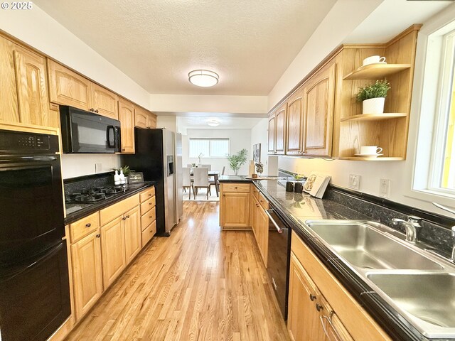 kitchen with kitchen peninsula, a textured ceiling, sink, light hardwood / wood-style flooring, and dishwasher