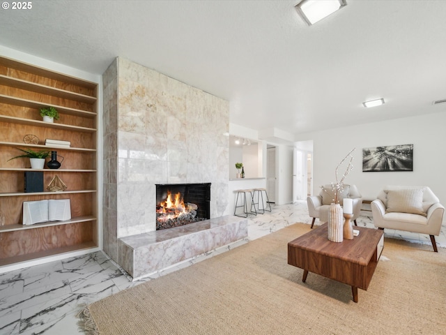 6325 SW Elm Ave, Beaverton, OR 97005 - living room featuring a premium fireplace, marble look tiles, and built in features