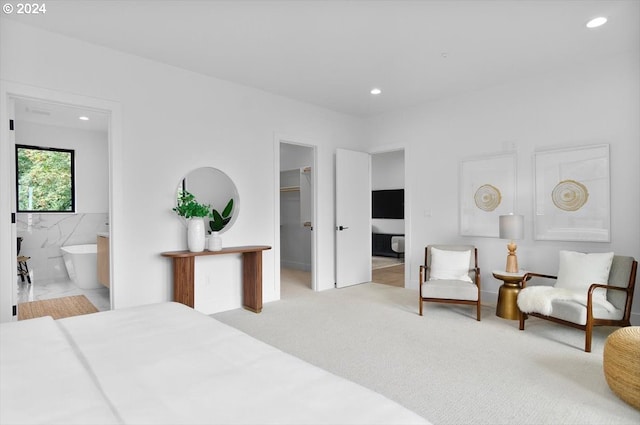 carpeted bedroom featuring tile walls, connected bathroom, a spacious closet, and a closet