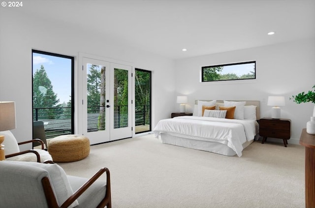 bedroom with french doors, light colored carpet, and access to exterior