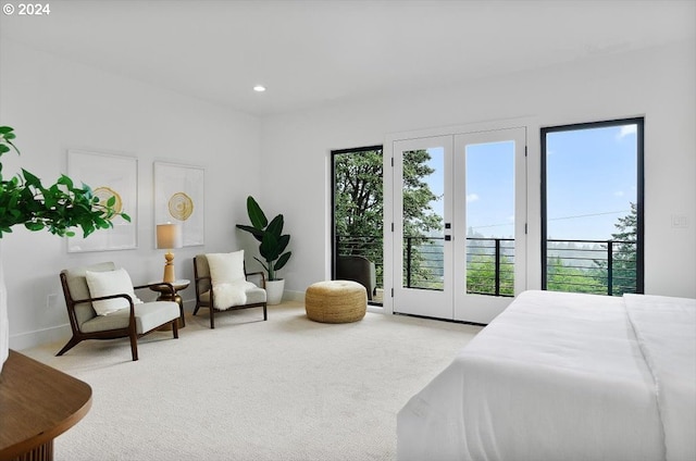 bedroom featuring french doors, light colored carpet, and access to outside