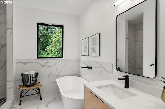 bathroom featuring tile walls, a tub to relax in, and vanity