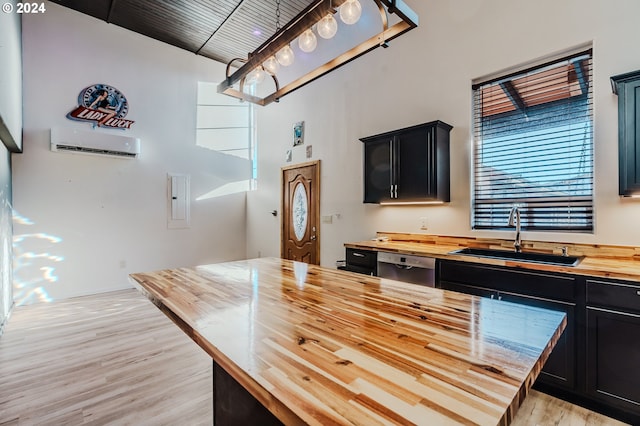 kitchen featuring a wall mounted air conditioner, wood counters, dishwasher, sink, and light hardwood / wood-style flooring