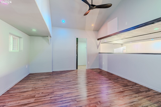 spare room with ceiling fan, light hardwood / wood-style floors, and vaulted ceiling