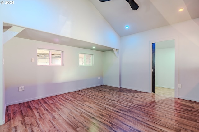 spare room featuring high vaulted ceiling, light hardwood / wood-style flooring, and ceiling fan