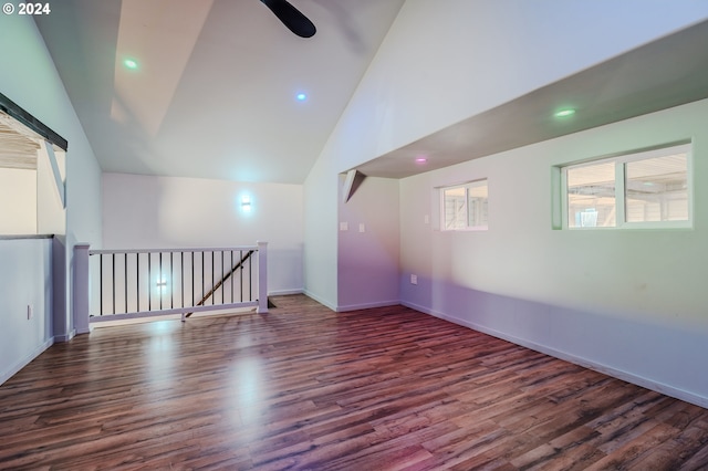 additional living space featuring dark hardwood / wood-style flooring, high vaulted ceiling, and ceiling fan