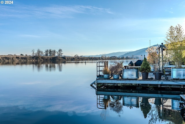 view of dock featuring a water and mountain view