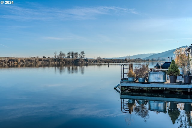 dock area featuring a water and mountain view