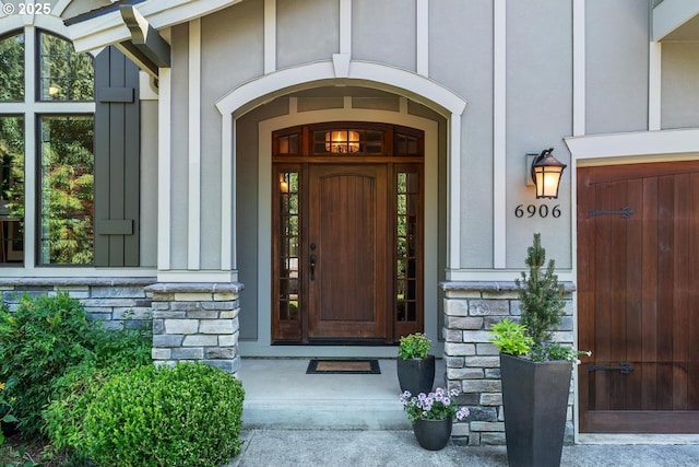 doorway to property with stone siding