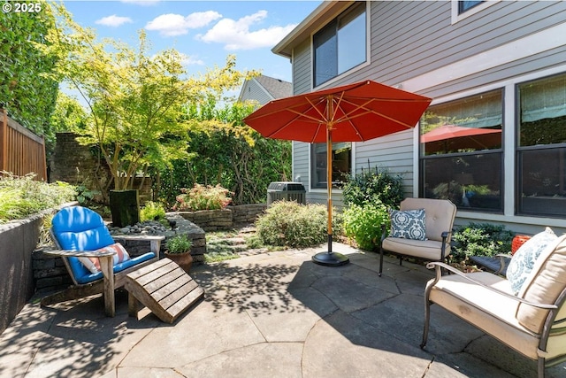 view of patio featuring area for grilling and fence