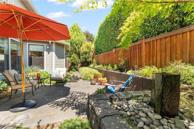 view of patio featuring fence